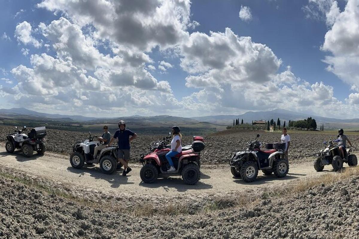 a group of people riding atvs on a dirt road