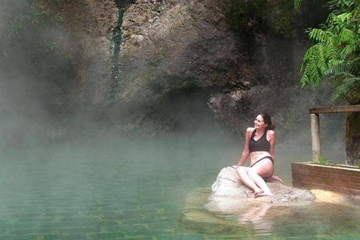 a woman sitting on an elephant in the water