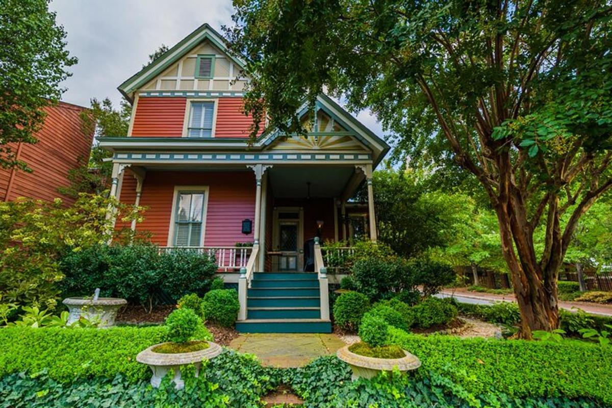 a red house with a porch and stairs in front