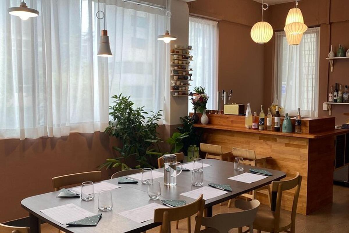 a dining room with a table with wine glasses on it