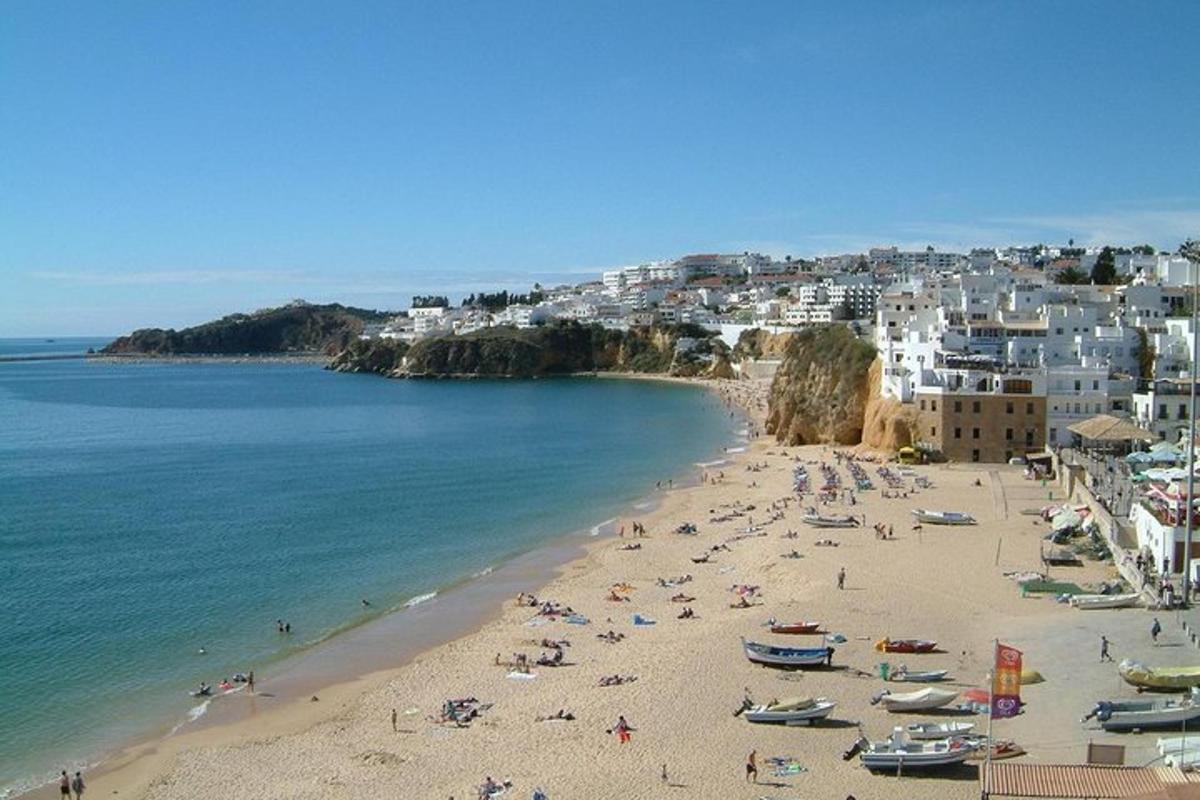a beach with a bunch of people and boats on it
