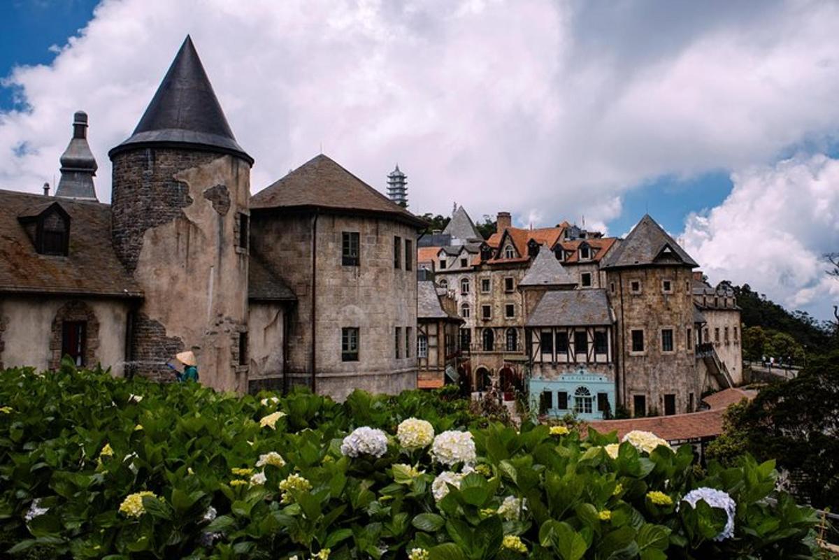 un castell antic amb un munt d'edificis i flors