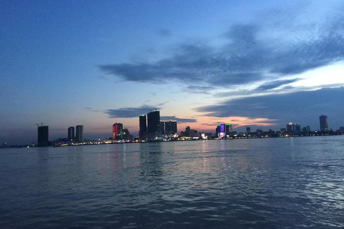 a large body of water with a city in the background