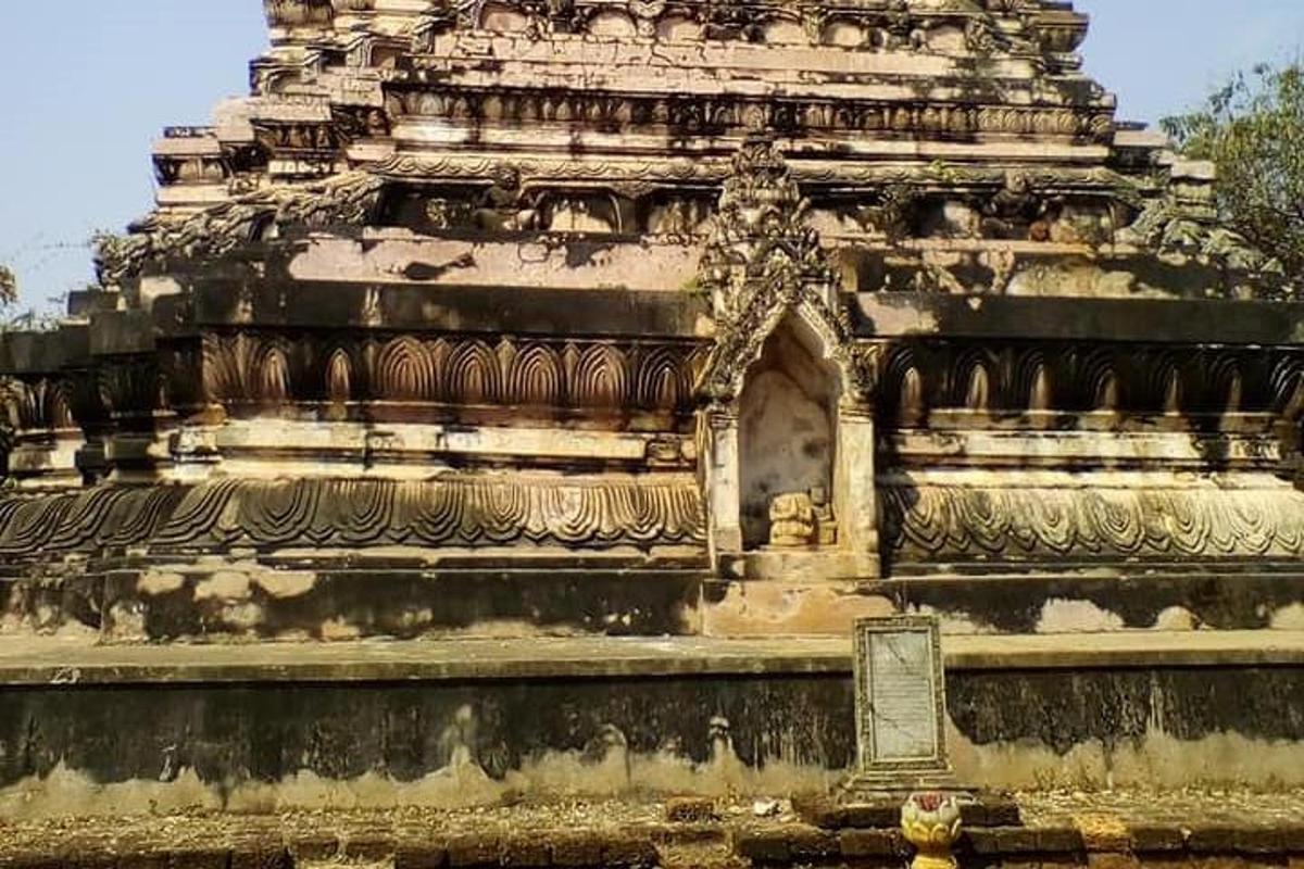 a large stone building with a statue on it