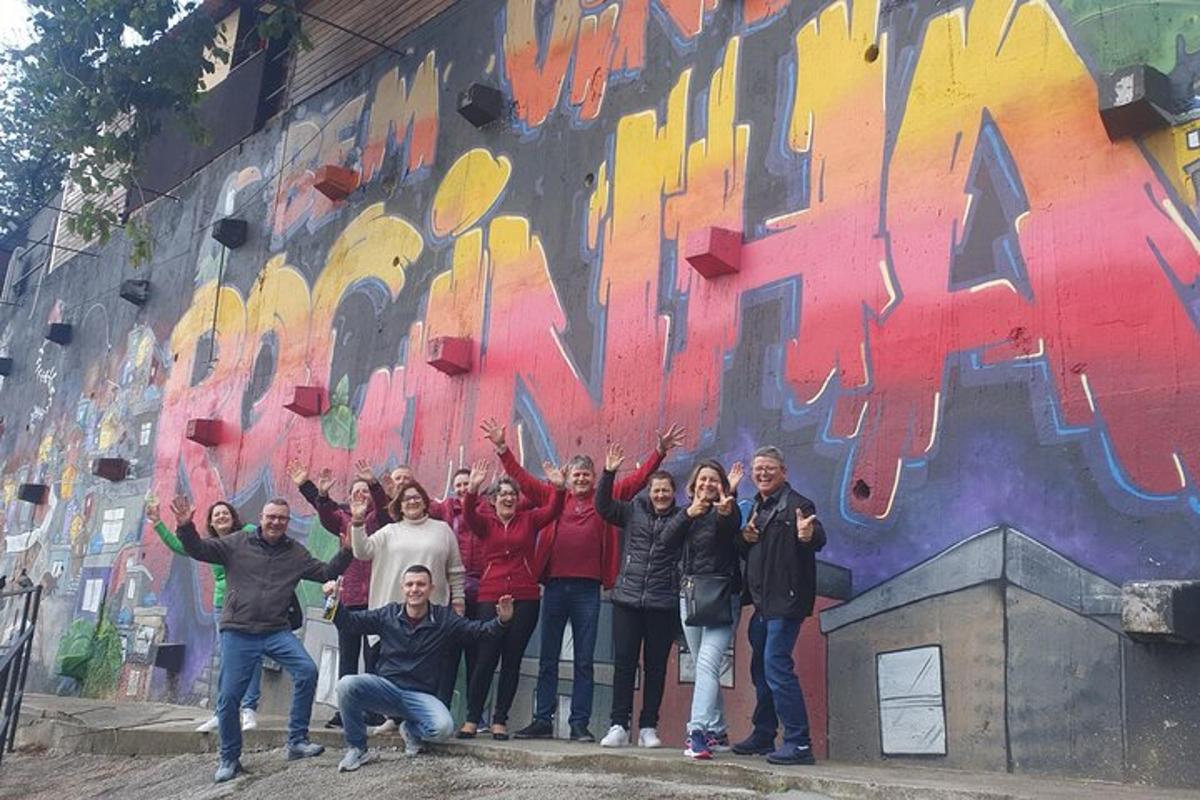 a group of people standing in front of a wall with graffiti