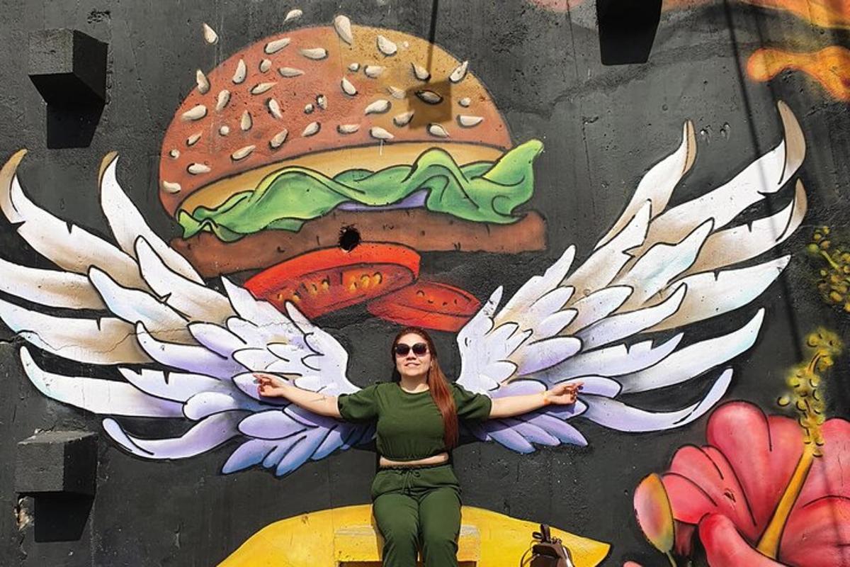 a woman standing in front of a painting of a hamburger
