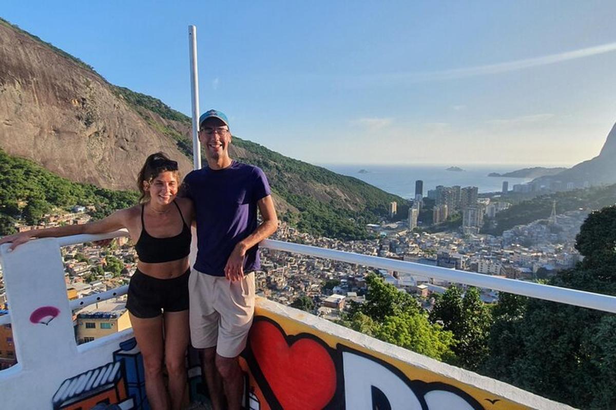 a man and a woman standing on top of a mountain