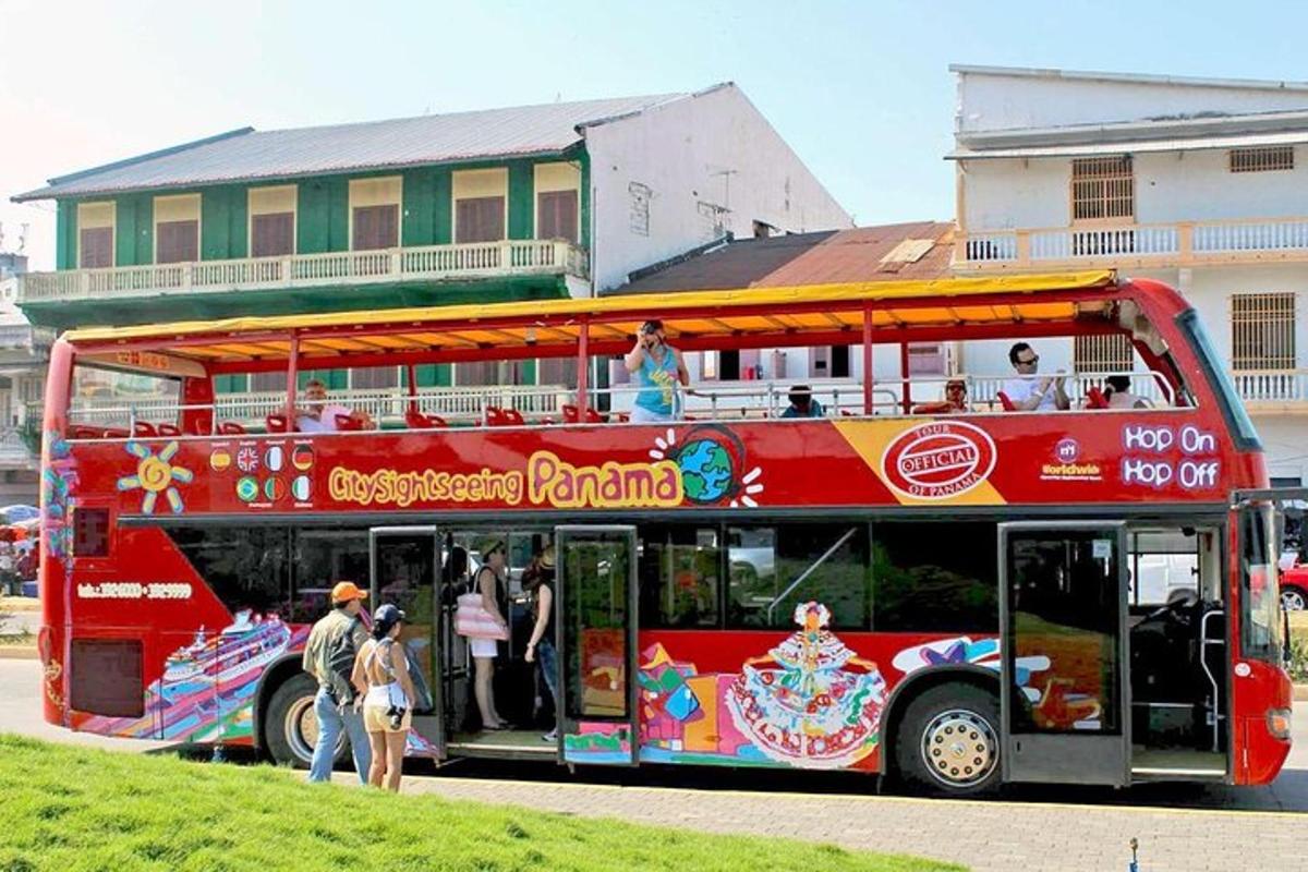 a red double decker bus parked in front of a building