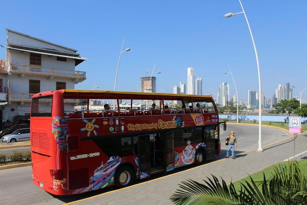 a red double decker bus driving down a street