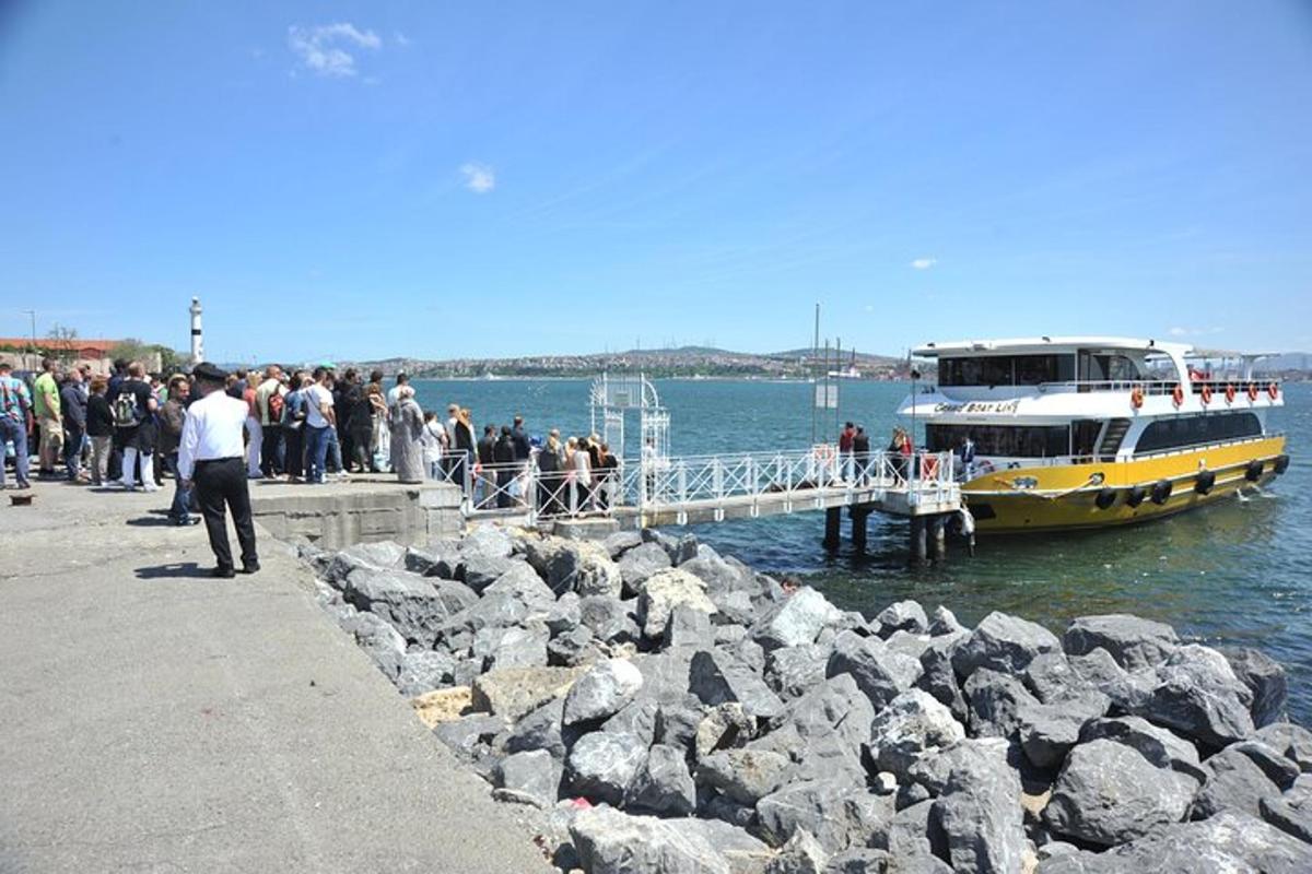 a group of people waiting to board a ferry