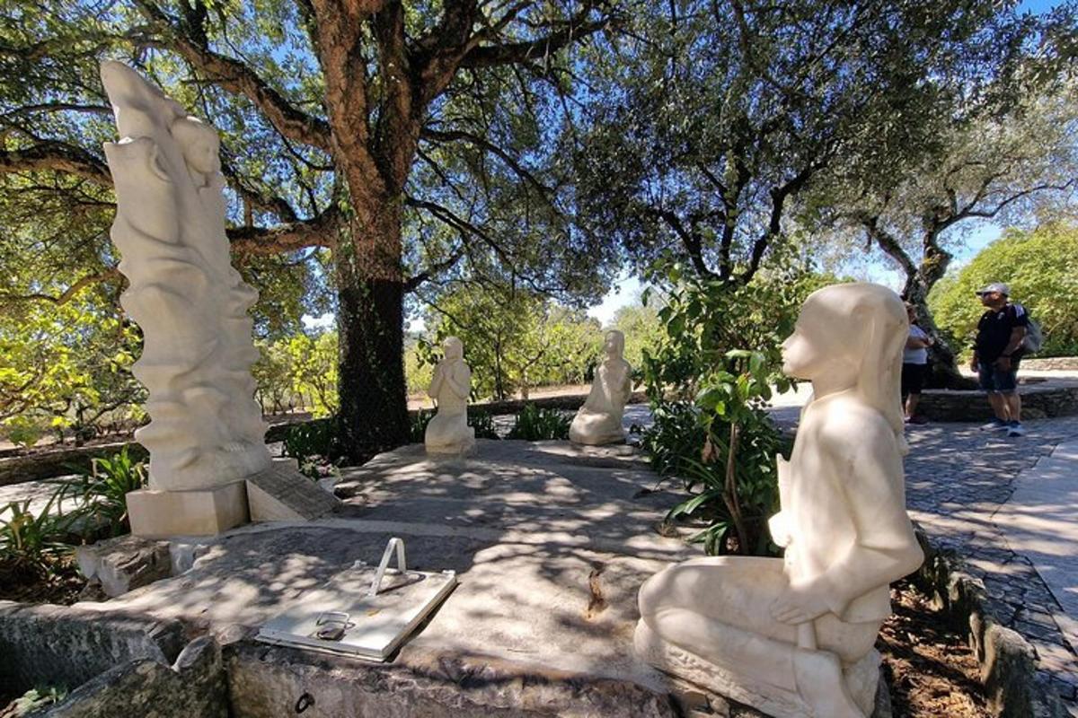 a group of statues sitting in a park
