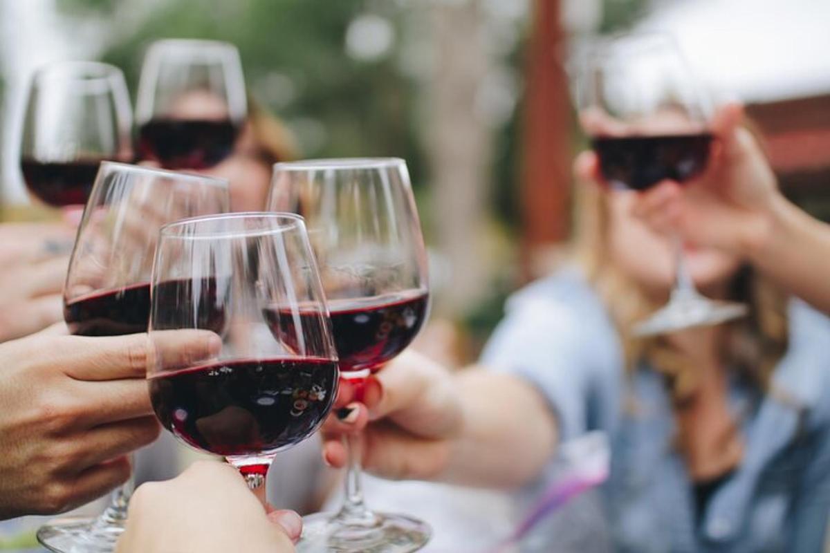 un gruppo di persone che sorreggono bicchieri di vino