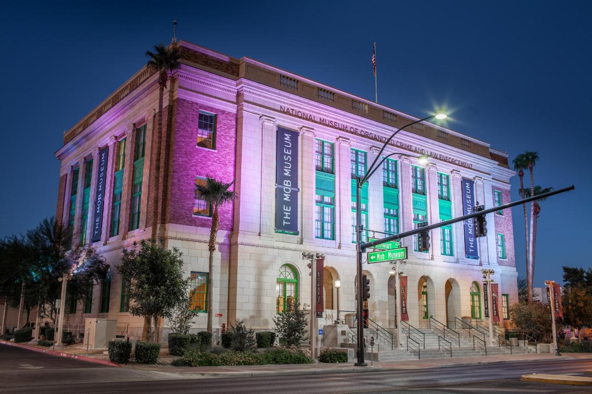 a building lit up in purple and green