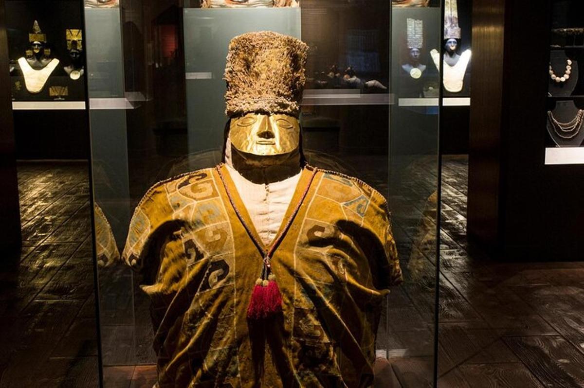 a statue of a man in a glass case in a museum