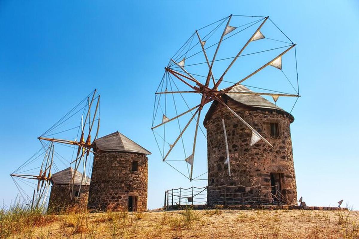 two stone windmills sitting on top of a hill