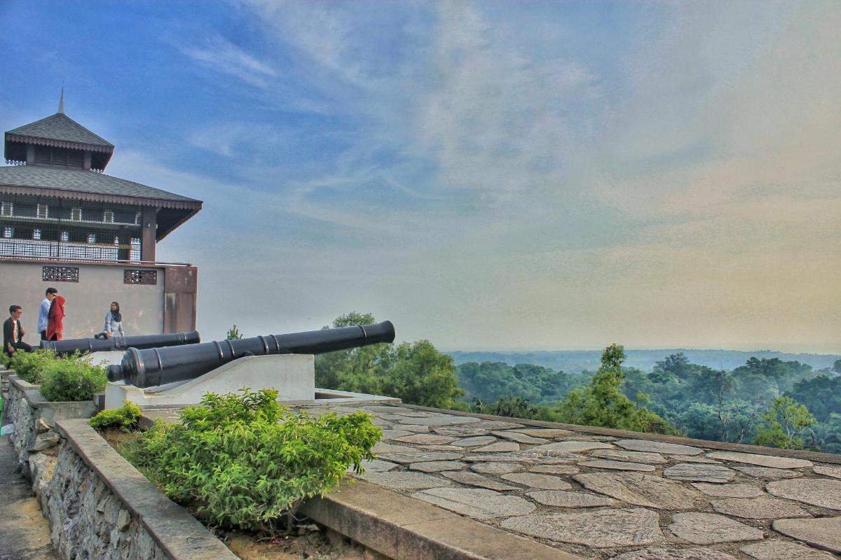 a cannon on the side of a building with a view