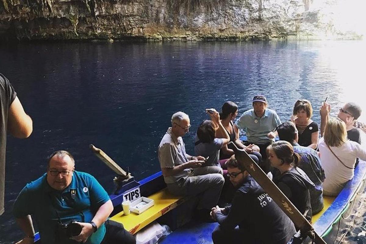 a group of people sitting on a boat in the water
