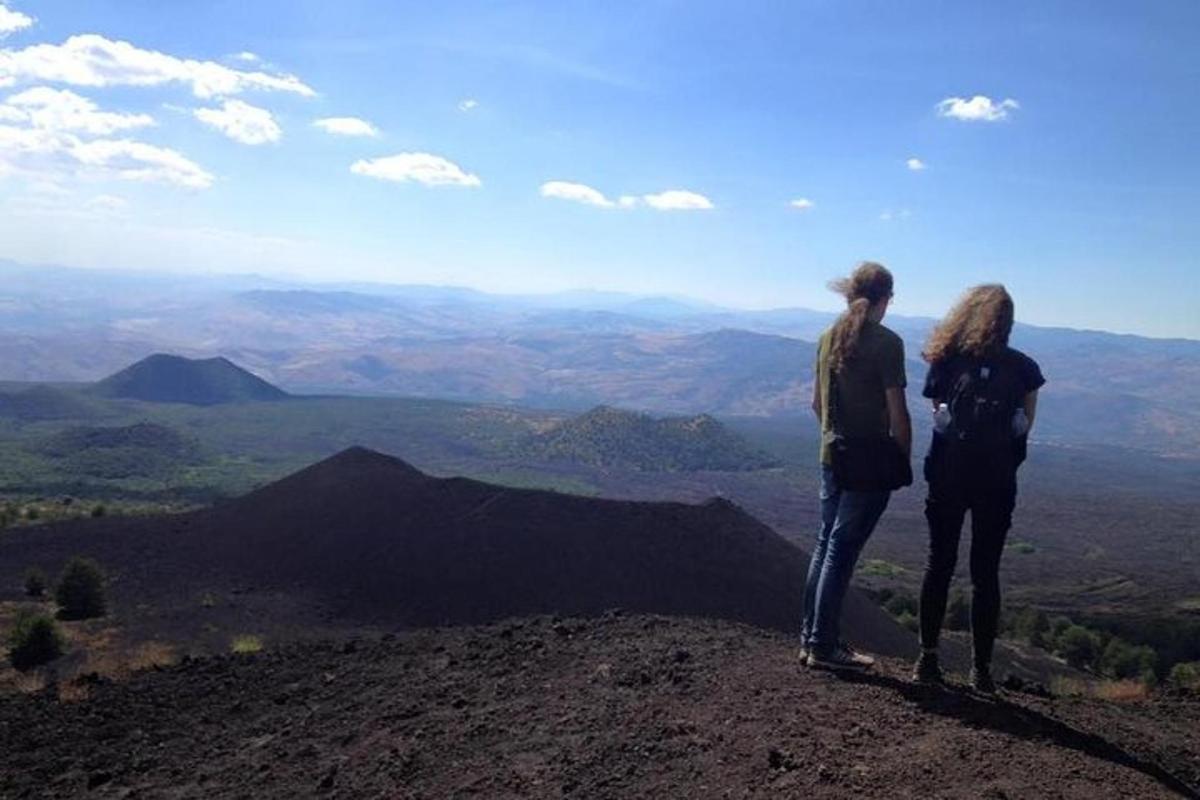 two people standing on the top of a mountain