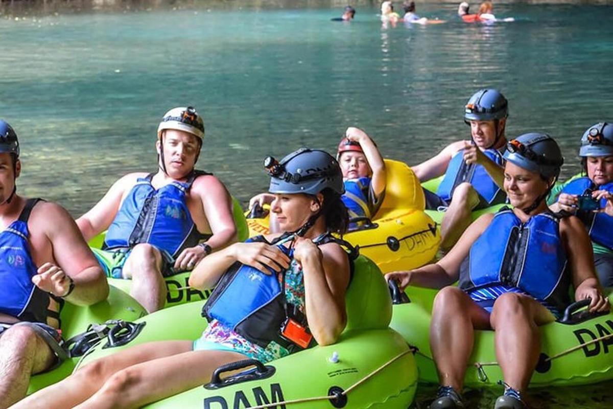 a group of people sitting on rafts in the water