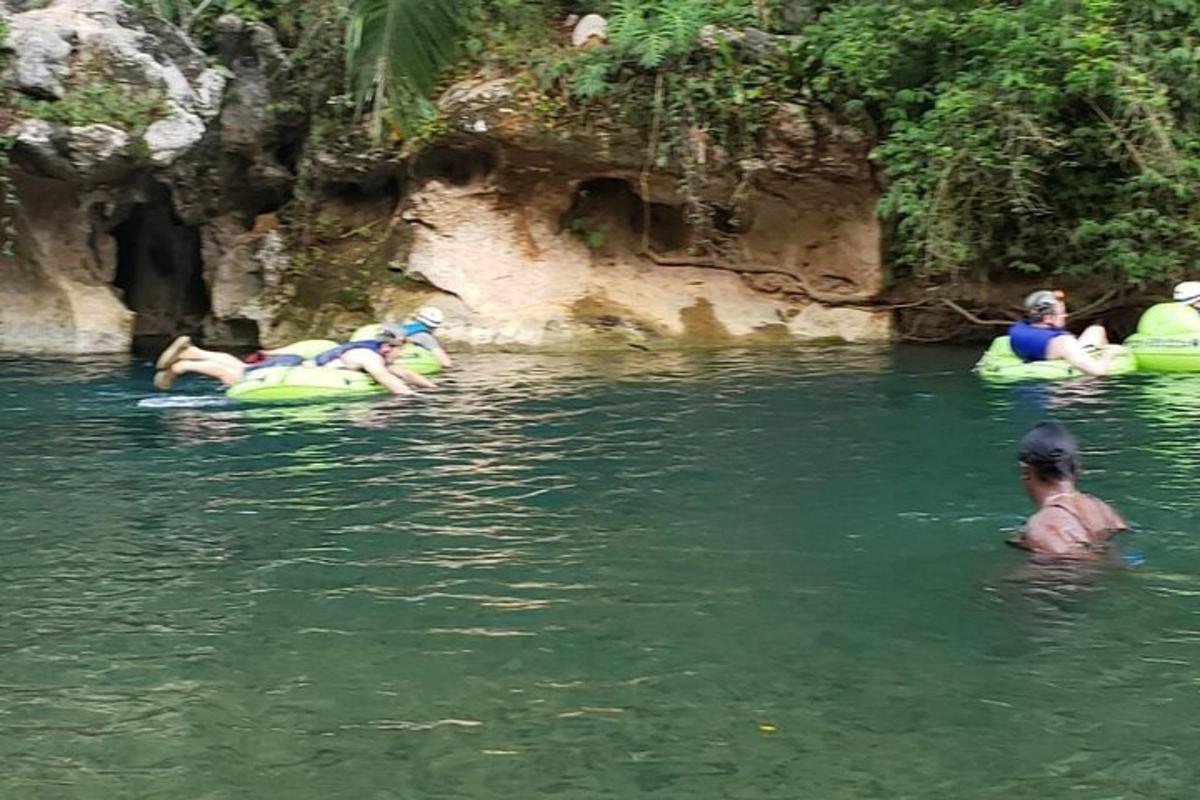 a group of people in the water on tubes