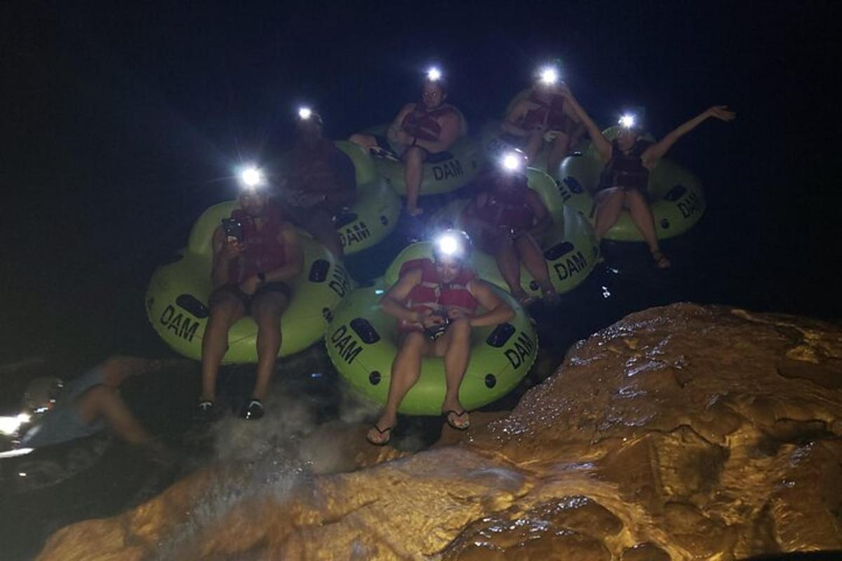 a group of people sitting on a raft in the water