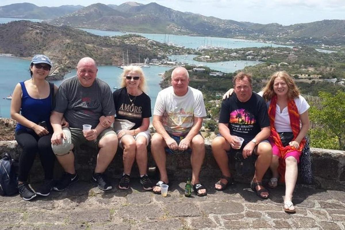 a group of people posing for a picture on a mountain