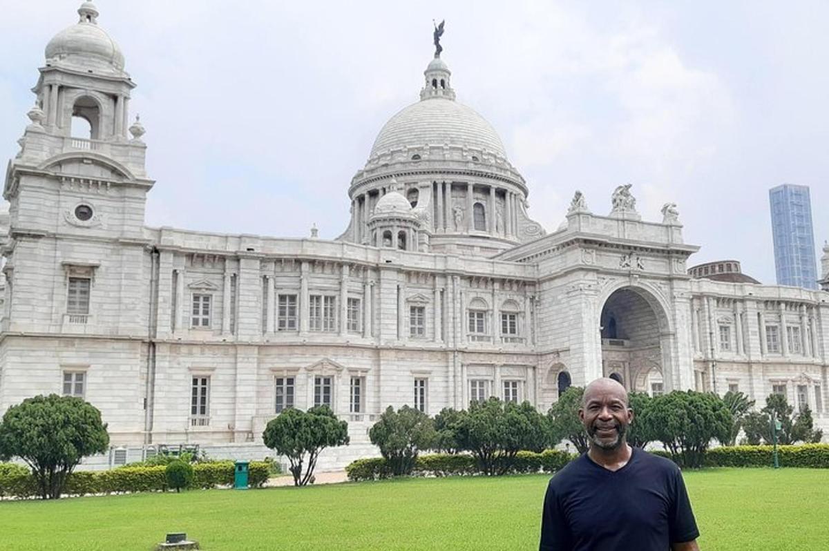 a man standing in front of a large building