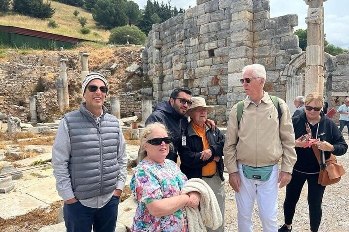 a group of people standing in front of a ruin