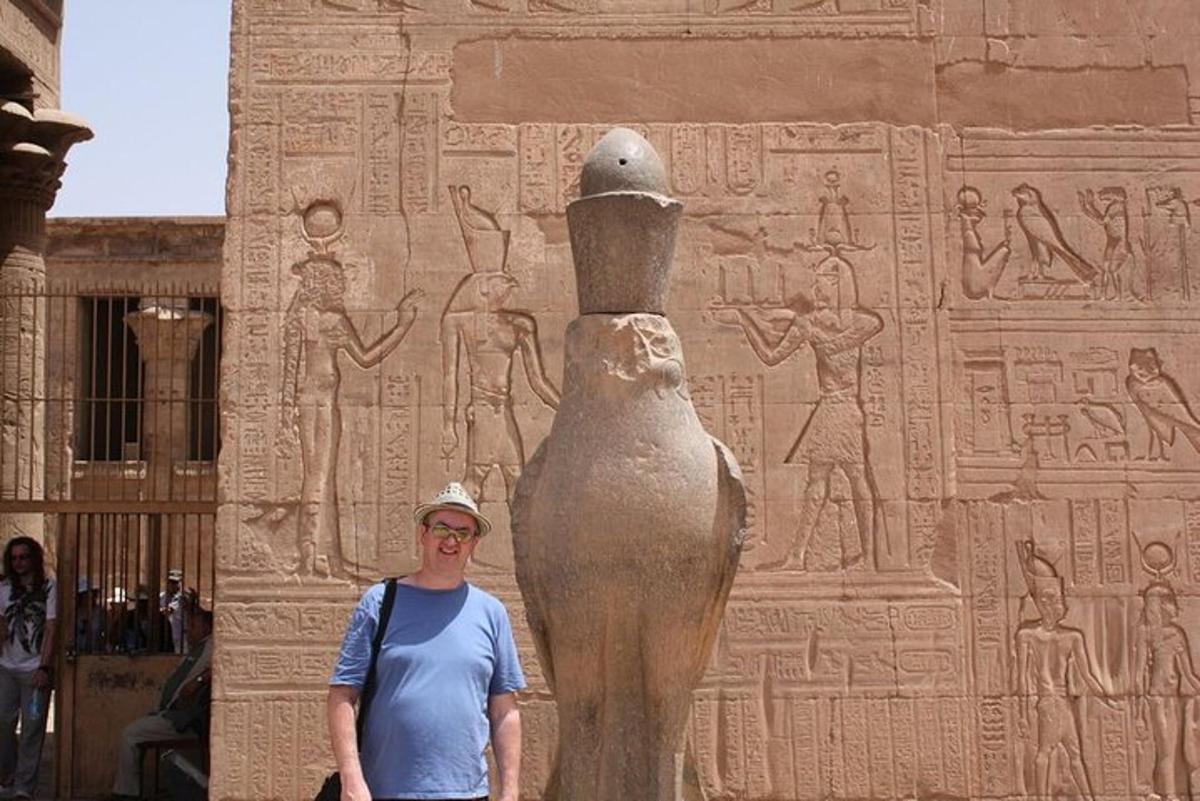 a man standing in front of a statue in front of anaraoh