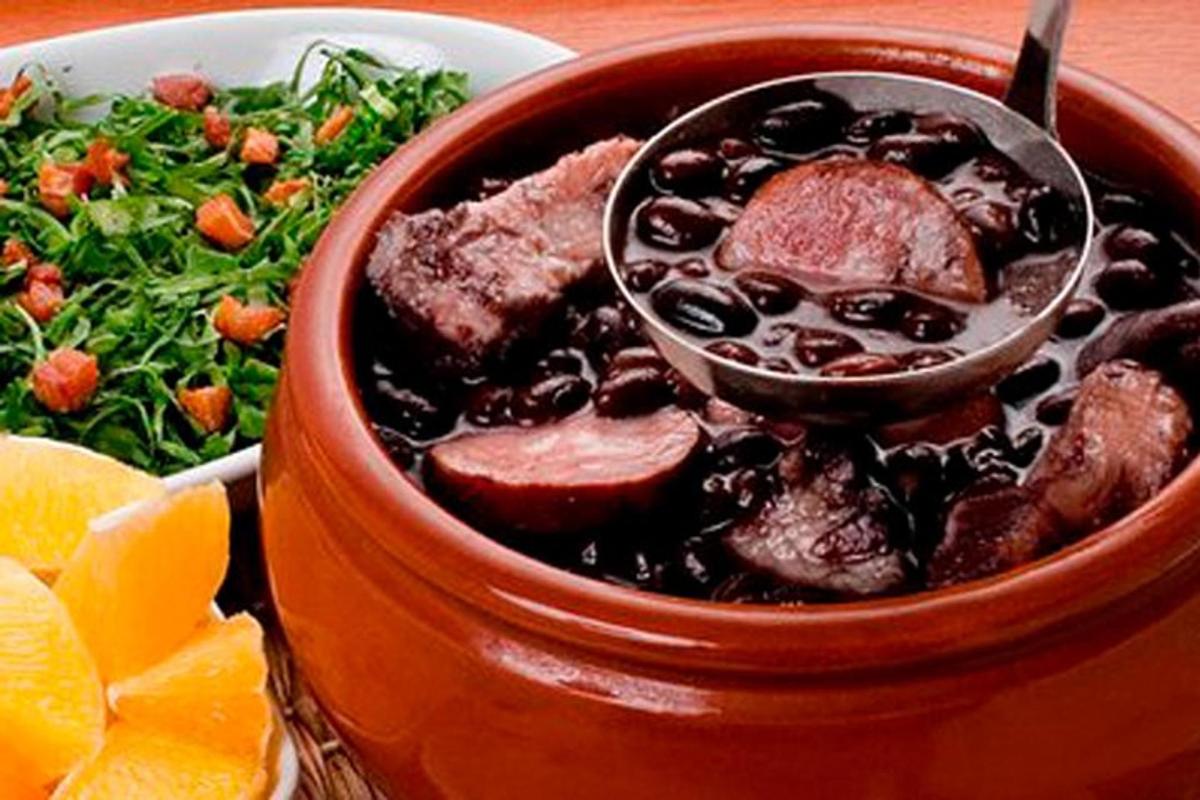 a bowl of food with meat and beans and a salad