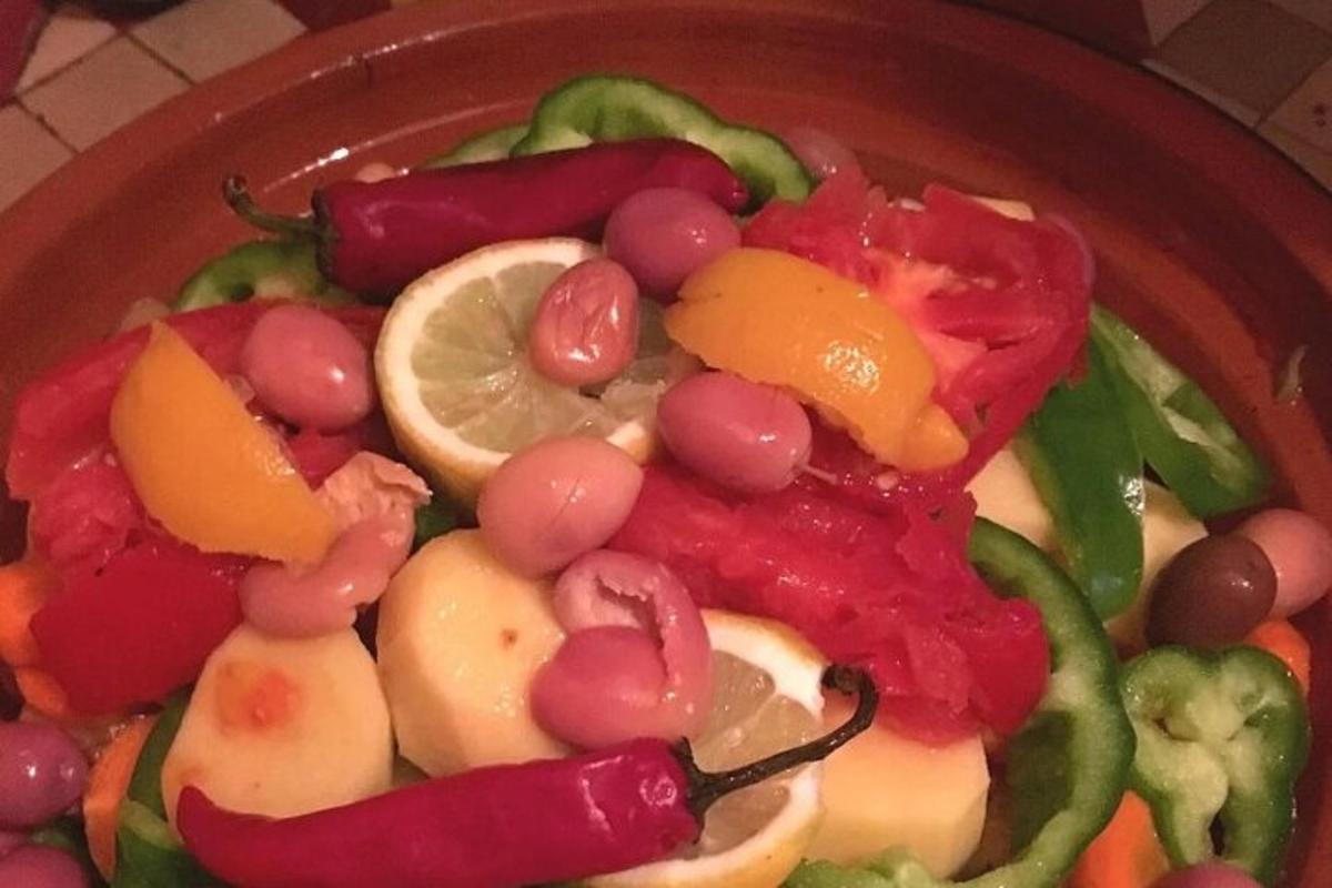 a bowl of food with grapes and other vegetables