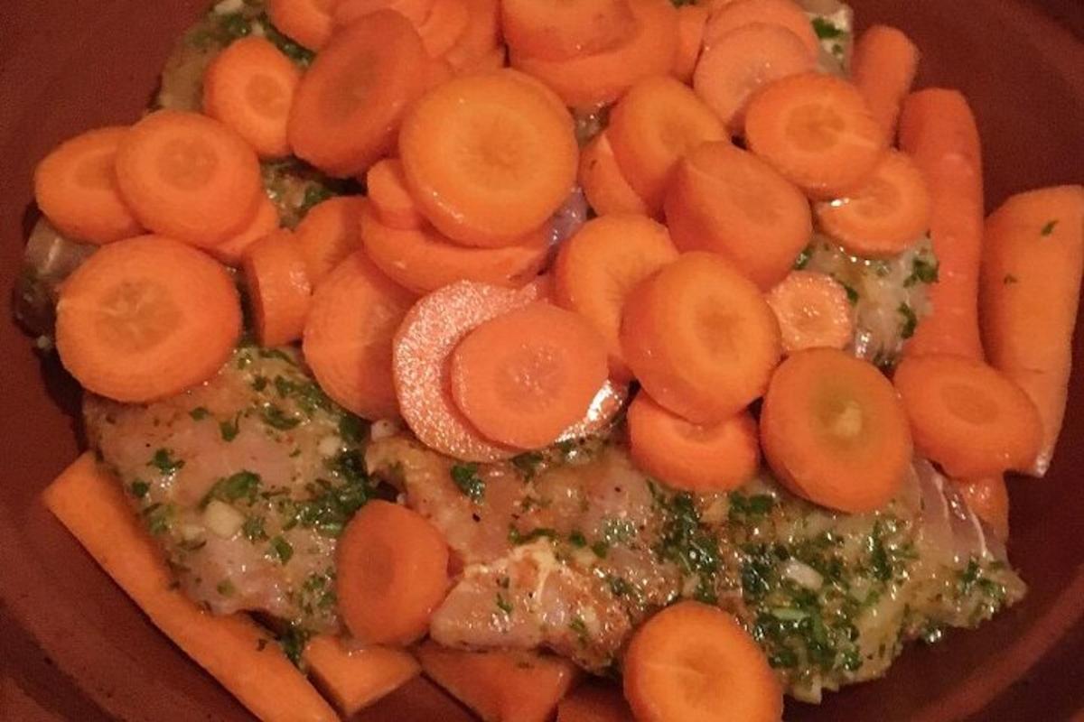 a plate of carrots and meat on a table