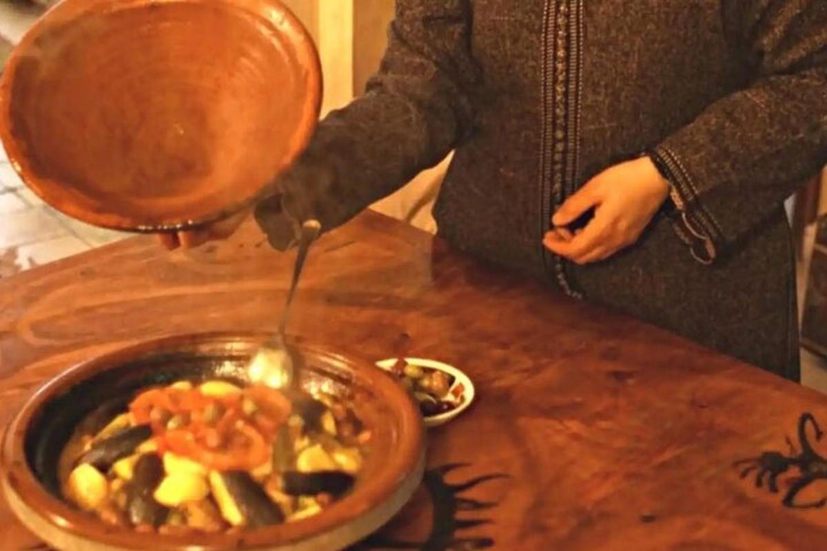 a woman is cooking a bowl of food on a table