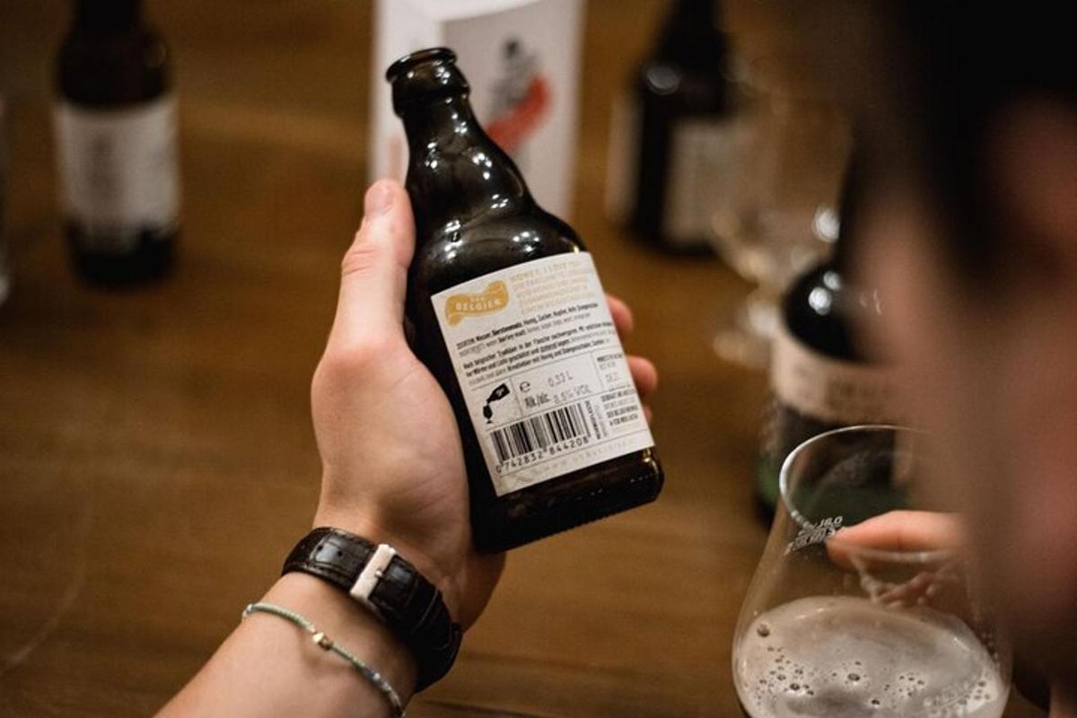 a person holding up a bottle of wine