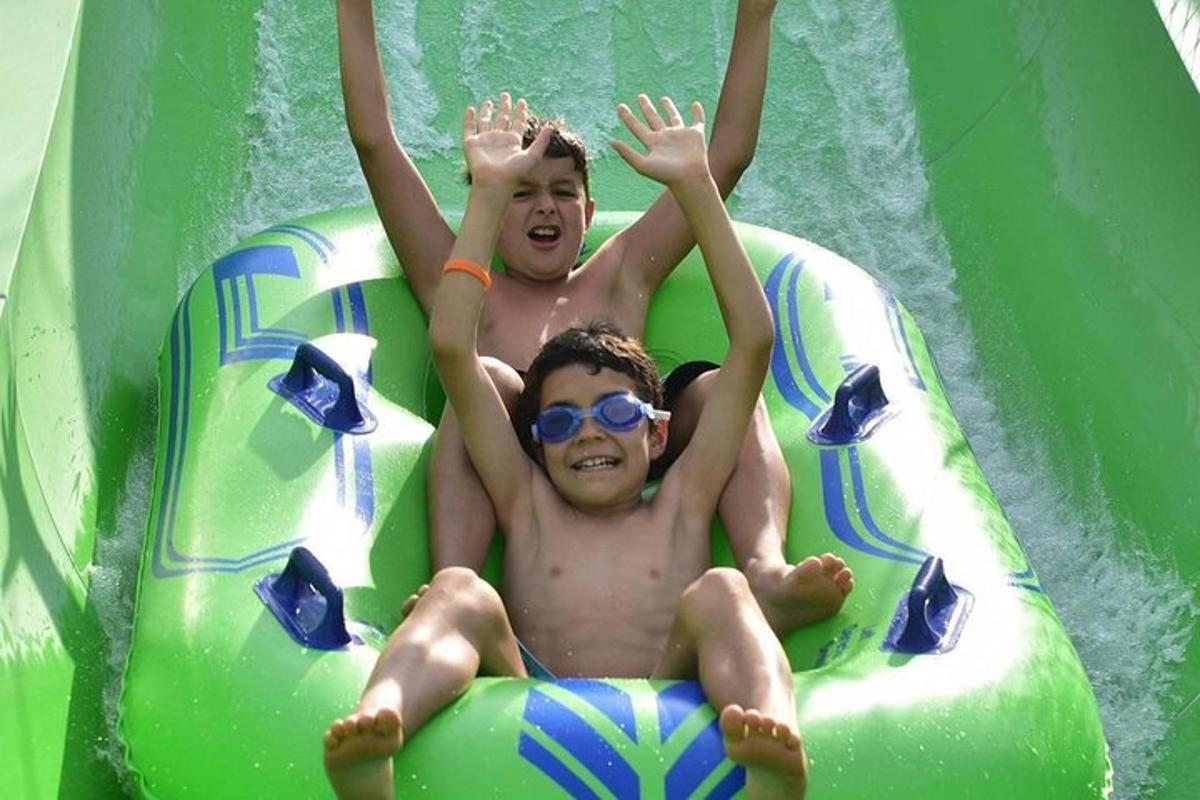 two young men laying on a raft in a pool