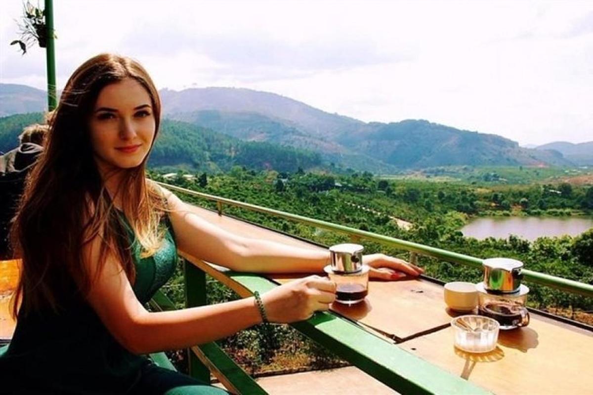 a woman sitting at a table with two glasses of wine