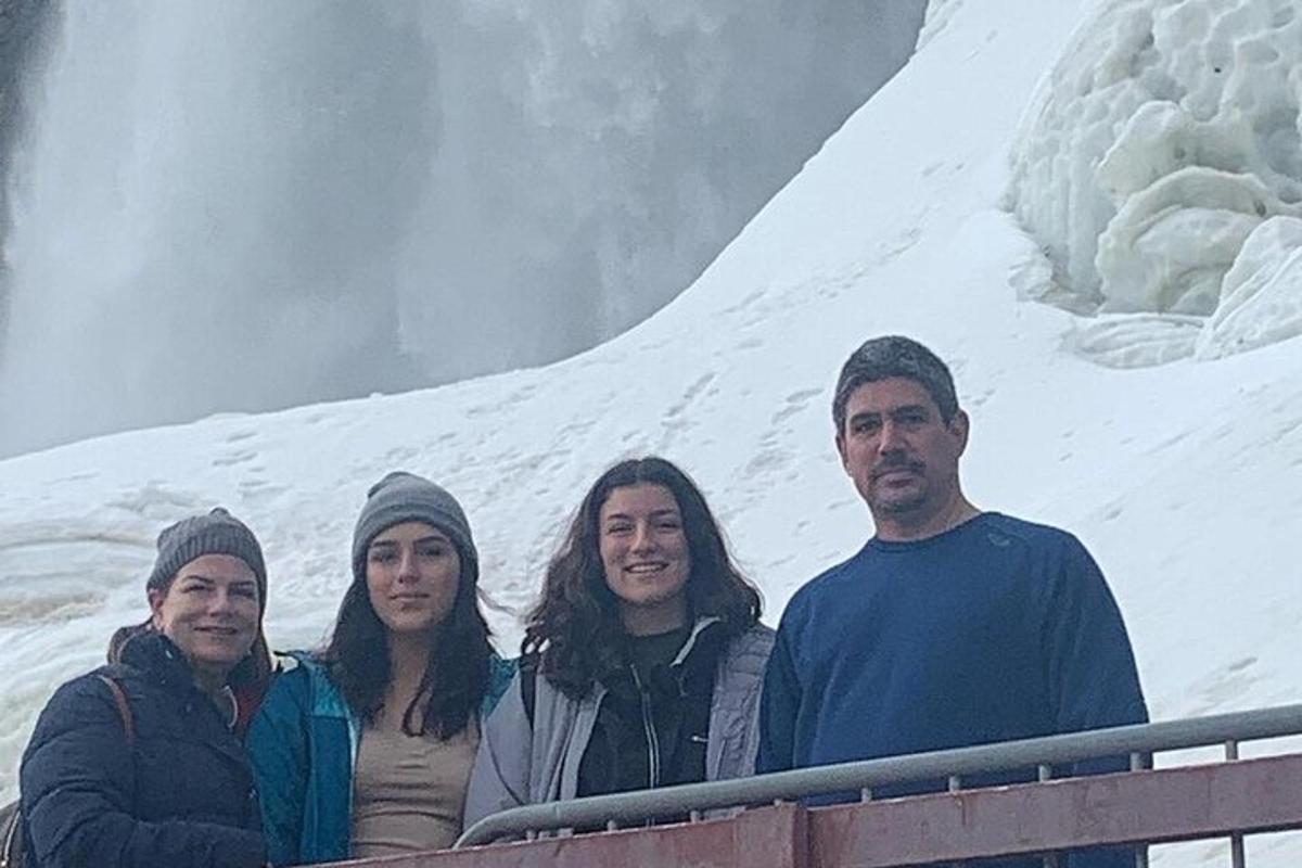a group of people standing in front of a mountain