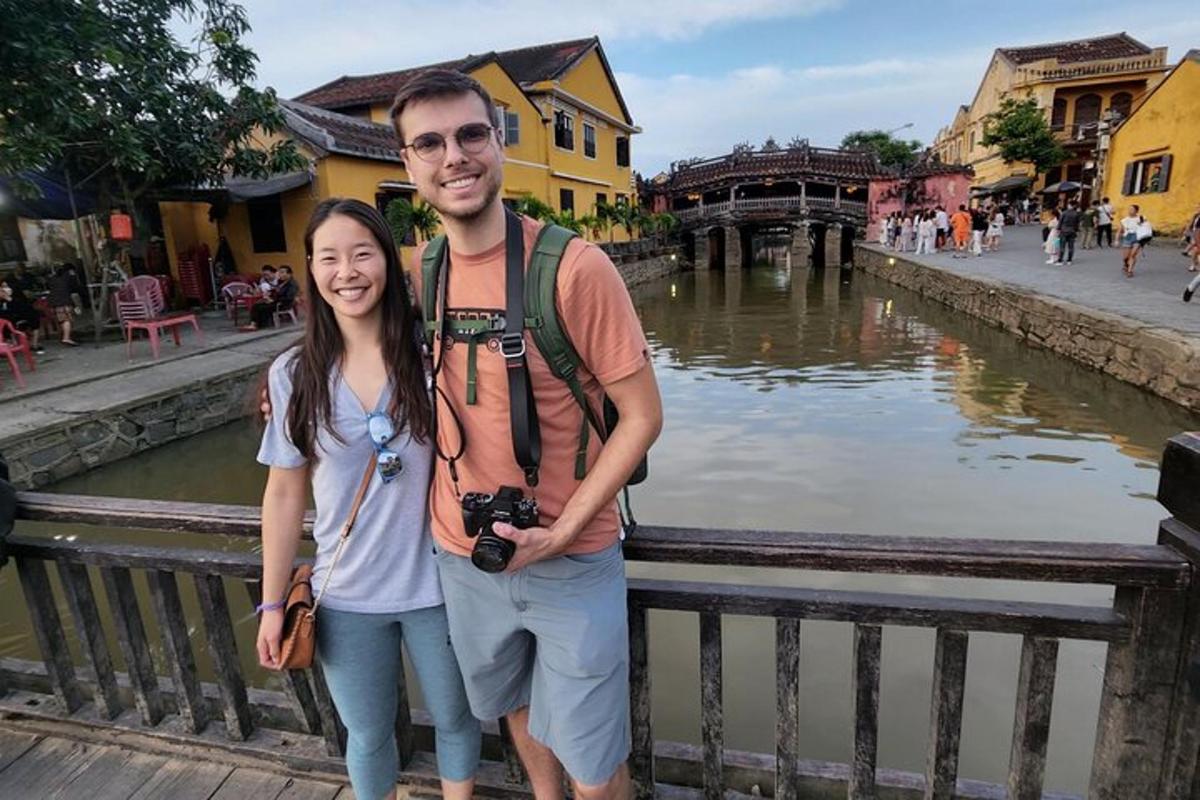a man and a woman standing next to a river
