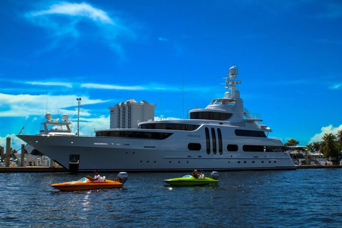 a large cruise ship with people in canoes in the water