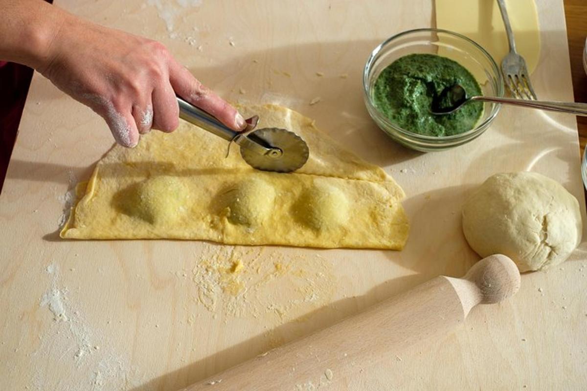 a person cutting a piece of bread on a cutting board