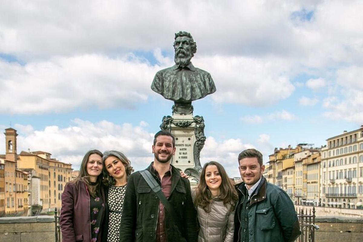Un grupo de personas de pie frente a una estatua