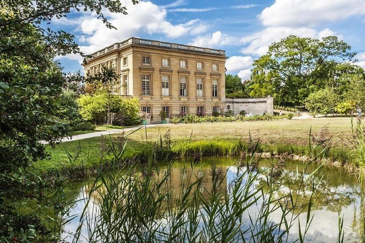 a large building with a pond in front of it
