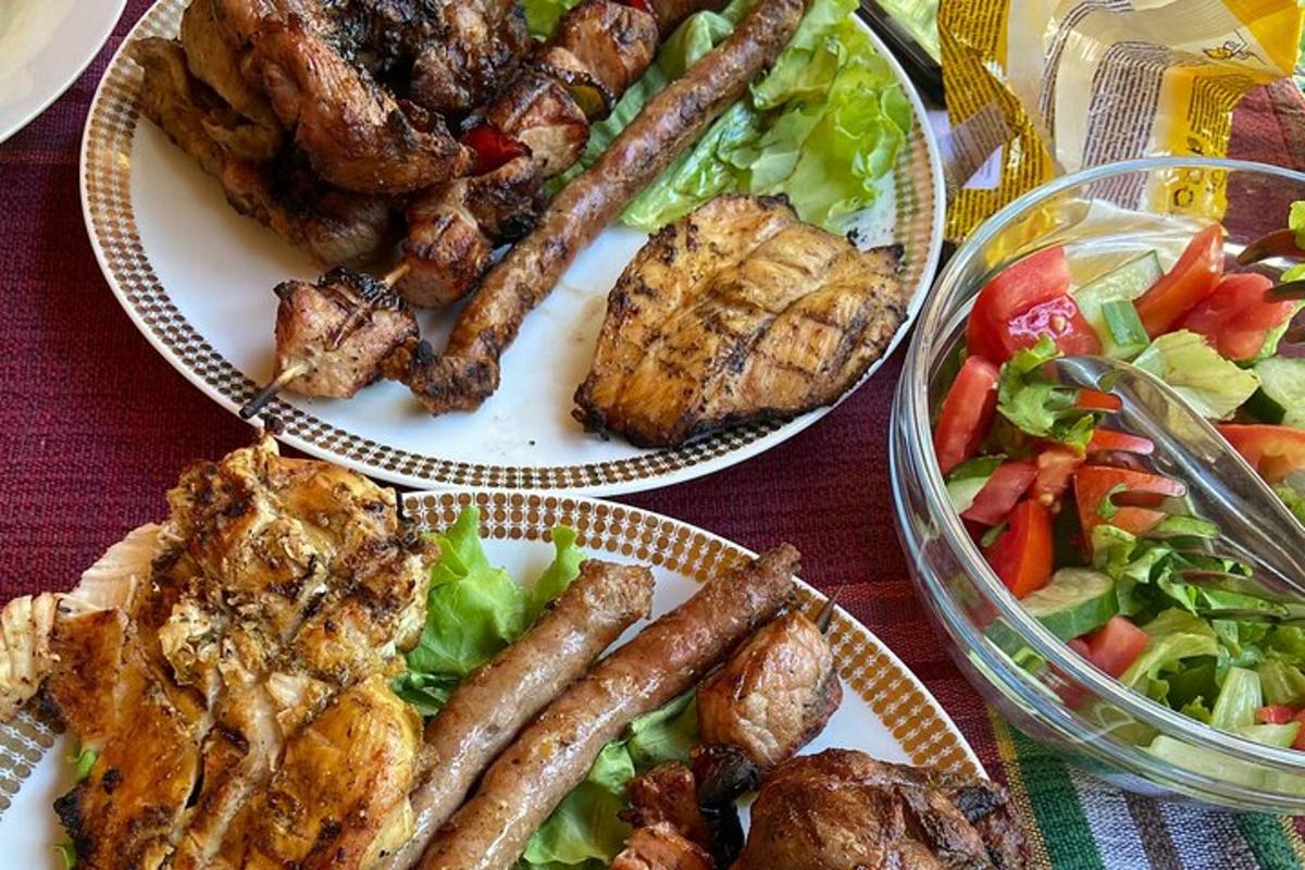a table with three plates of food and a salad