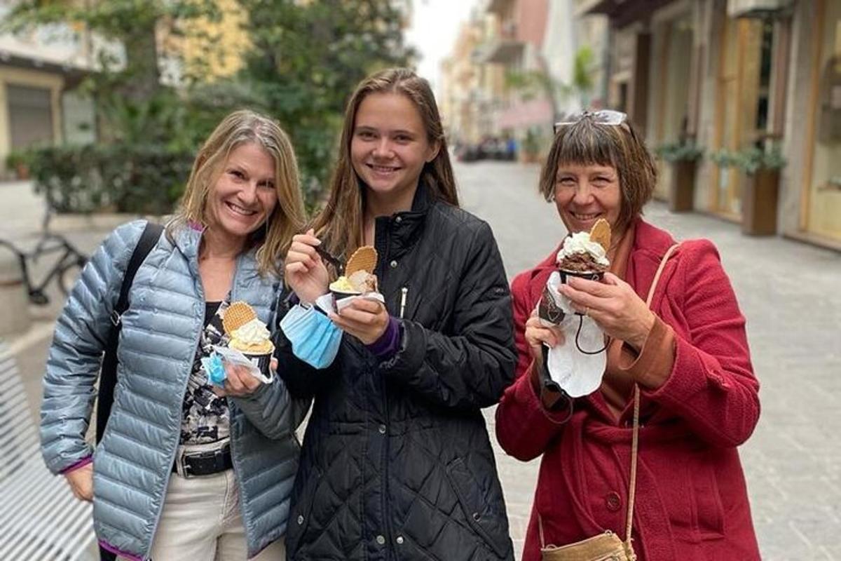 three women eating ice cream on a city street