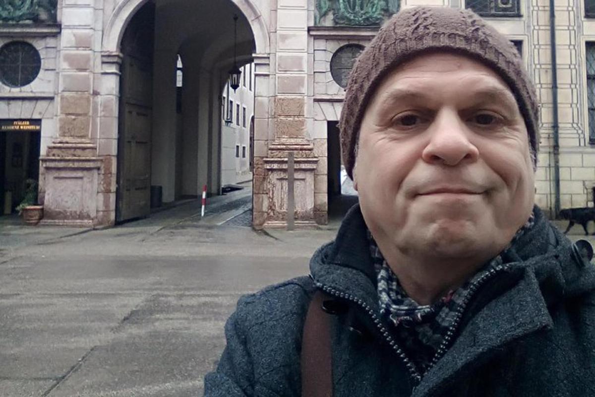 un bărbat care stă în fața unei clădiri