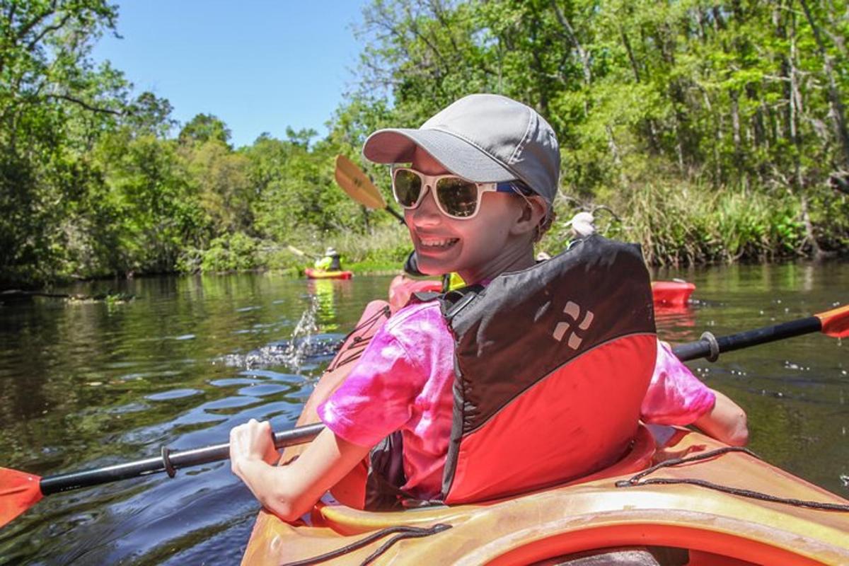 a young girl in a kayak on a river