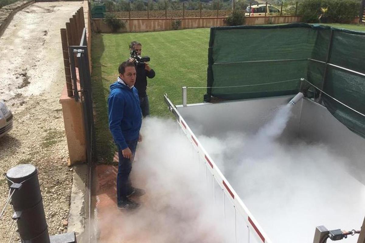 a man with a camera standing in front of smoke