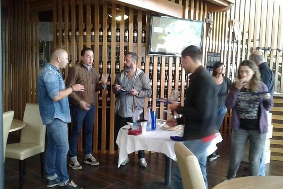 a group of people standing around a table in a room