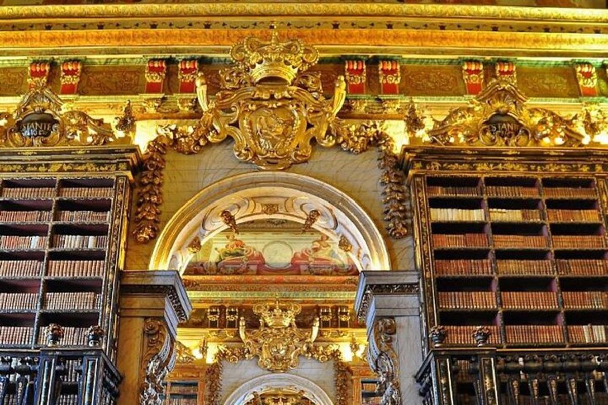 a library with golditures and books on a wall