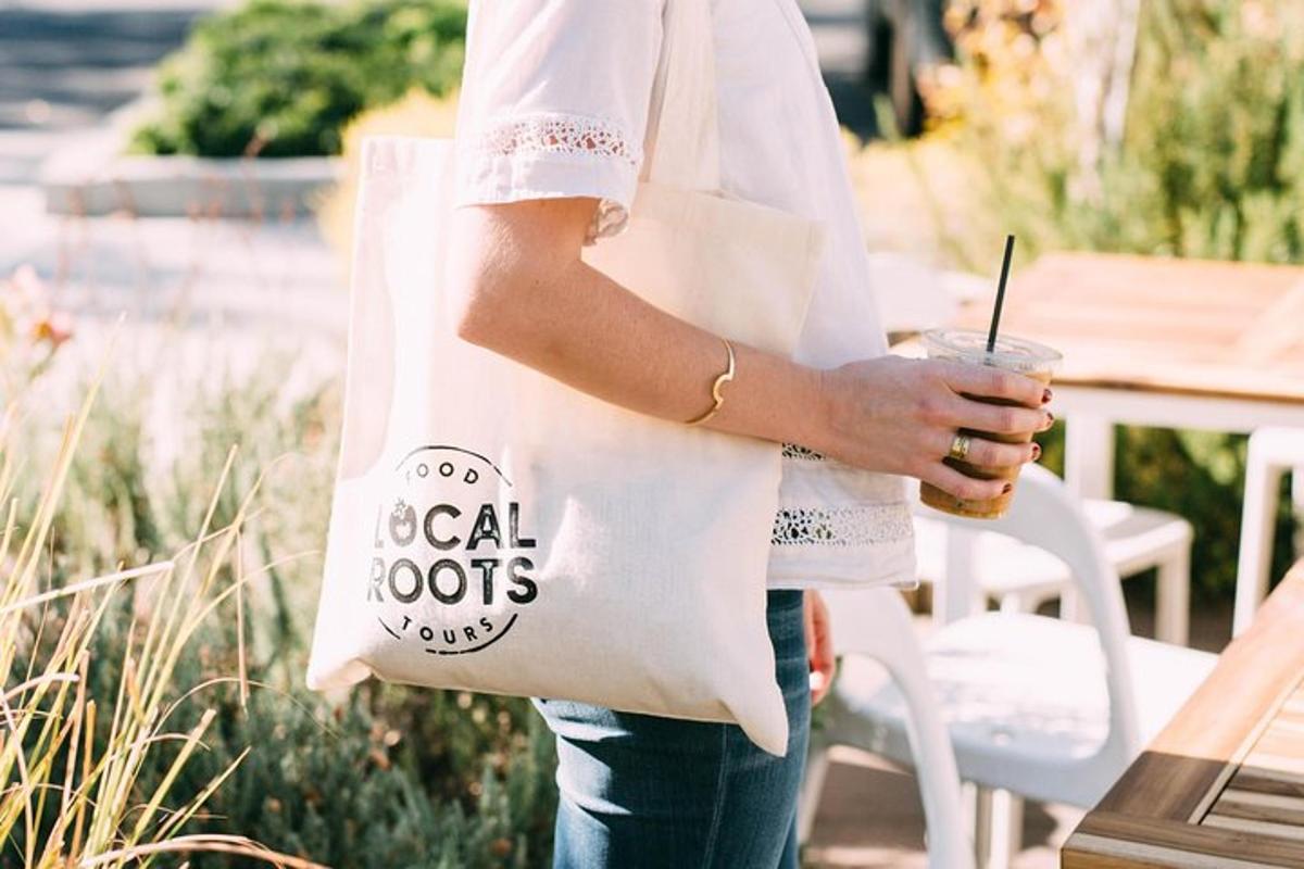 a woman holding a white bag with a drink
